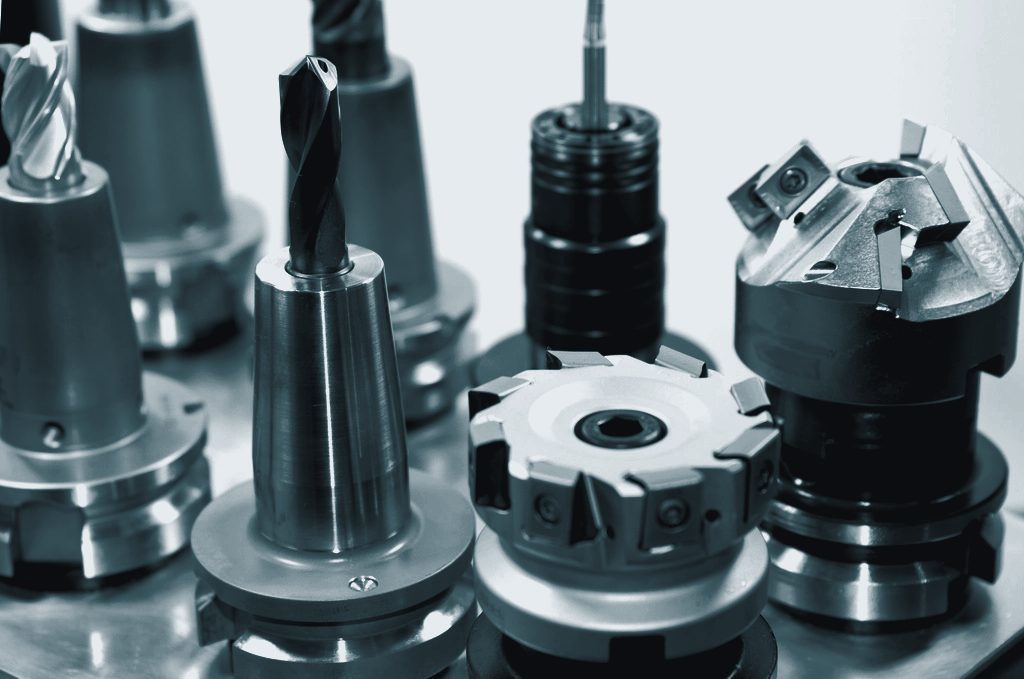 Tool holders with end mills, drills and indexable face mills lined up in a rack