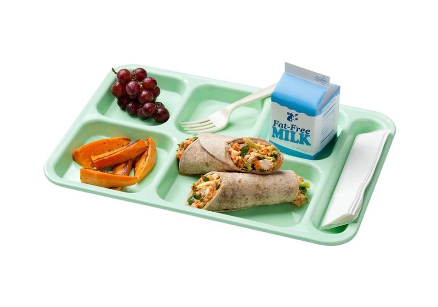 A lunch tray with grapes, sweet potato wedges and a wrap
