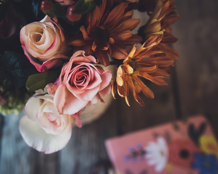 Blush and cream roses with bronze chrysanthemums, seen from above