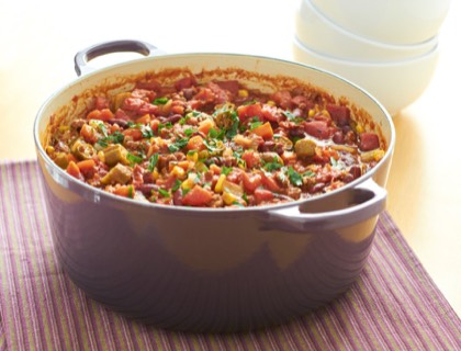 Pot of vegetable chili with beans, corn and herbs