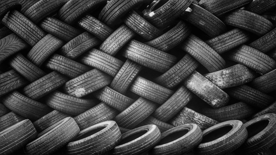 A wall of tires stacked in a woven pattern