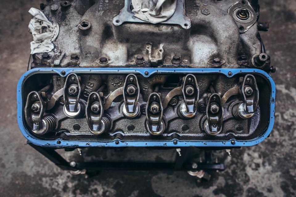 Overhead view of a V8 cylinder head with its valve cover off, showing rocker arms and valve springs